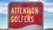 Panorama frame Attention Golfers sign at a golf course with blurry mountain and sky background