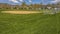 Panorama frame Baseball or softball field with buildings and trees beyond the grassy terrain