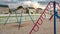 Panorama frame Climbing bars swings and slides on a neighborhood playground against cloudy sky