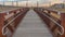 Panorama frame Close up of a bridge with a wooden deck and brown metal guardrails