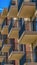Panorama frame Close up of building exterior with brick small balconies and red brick wall