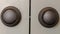 Panorama frame Close up view of matte black round door knobs of a gray bedroom double door