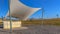 Panorama frame Concrete rectangular structure under a white canopy viewed on a sunny day