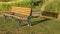 Panorama frame Empty outdoor park bench casting shadow on the grassy terrain on a sunny day