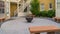Panorama frame Fire pit on circular pavement with stone benches against building exterior