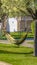 Panorama frame Hammock tied to the branches of trees with white flowers in spring