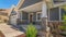 Panorama frame Home facade with view of yard and gable roofs over garage and front porch