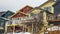 Panorama frame Homes with porches balconies and outdoor stairs under gray cloudy sky in winter