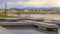 Panorama frame Lake with wooden deck and benches overlooking houses beyond the grassy shore