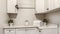 Panorama frame Laundry room of home with white wood cabinets and clothes rod against wall