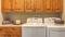 Panorama frame Laundry room interior with washer dryer and counter against the beige wall