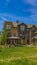 Panorama frame Lush lawn in the middle of townhomes under blue sky on a sunny day