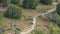 Panorama frame Narrow hiking trail curving through the grassy terrain of a mountain