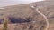 Panorama frame Narrow trail on a brown hill with hazy sky in the background