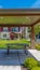 Panorama frame Patio on a lawn surrounded by houses under blue sky