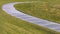Panorama frame Paved footpath that curves through the grassy terrain viewed on a sunny day