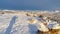 Panorama frame Snowy hilltop over looking Utah Vally community and mountain against blue sky