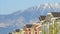 Panorama frame Snowy mountain and blue lake view behind townhouses with colorful exterior walls