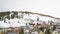 Panorama frame Vast cloudy sky over houses built on a hill blanketed with fresh snow in winter