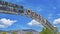 Panorama frame The welcome arch in Ogden Utah against vibrant trees and towering mountain