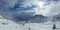 panorama of fresh snow in tyrolean ski resort with ski tracks sky