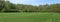 Panorama of the freshly cut spring football lawn of the club of