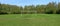 Panorama of the freshly cut spring football lawn with gated of