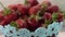 Panorama of a full blue vase of strawberries in the kitchen. Glare on the berry