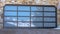 Panorama Garage door with glass panes reflecting a snowy hill landscape under blue sky