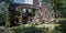 Panorama of the giant stone rock remains of a house in Jack london state historic park with a small fence on the right