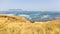 Panorama of Gibraltar with waves and many ships in the bay.