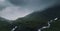 Panorama of gloomy cloudy Norwegeian mountains with springs, Norway