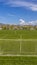 Panorama Goal nets and markings on a soccer field with houses and trees in the distance