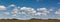 Panorama of the Gobi desert, the Expanses of Mongolia, mountains on the horizon, Blue sky with clouds. The serenity of the