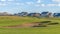 Panorama Golf course and houses with distant mountain and blue sky view on a sunny day