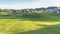 Panorama Golf course with sunlit fairway bunkers and putting green on a sunny day
