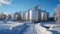 Panorama of grain silos in winter with snow and blue sky