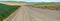 Panorama of a gravel road through farm fields in the Palouse region of southeastern Washington, USA