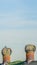 Panorama Green roof with metal turbine ventilator against cloudy pale blue sky