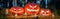 Panorama of Halloween pumpkin head jack o lanterns with burning candles in scary deep night forest. Halloween holiday design