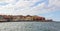 A panorama of the harbor city of Chania. View of the emarald sea, interesting landscapes, colorful houses, a coastline. Greece.