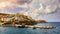 Panorama of Harbour with vessels, boats, beach and lighthouse in Bali at sunrise, Rethymno, Crete, Greece. Famous summer resort in