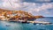 Panorama of Harbour with vessels, boats, beach and lighthouse in Bali at sunrise, Rethymno, Crete, Greece. Famous summer resort in