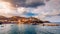 Panorama of Harbour with vessels, boats, beach and lighthouse in Bali at sunrise, Rethymno, Crete, Greece. Famous summer resort in