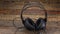 Panorama of headphones standing on a vintage wooden table.