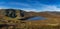 Panorama with heart shaped lake, Lough Ouler, reflecting blue sky and Tonelagee Mountain, Wicklow, Ireland