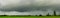 Panorama heavy clouds storm of rain on sky over rice field in rural