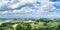 Panorama from a high altitude to a valley with fields and windmills. Hof, Bavaria, Germany.