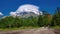 Panorama of high peaks with beautiful clouds on the peaks. Hikers on a mountain trail, cumulus. High Tatras Slovakia.