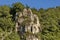 Panorama with high vertical limestone cliffs, overgrown with deciduous trees, Nisovo